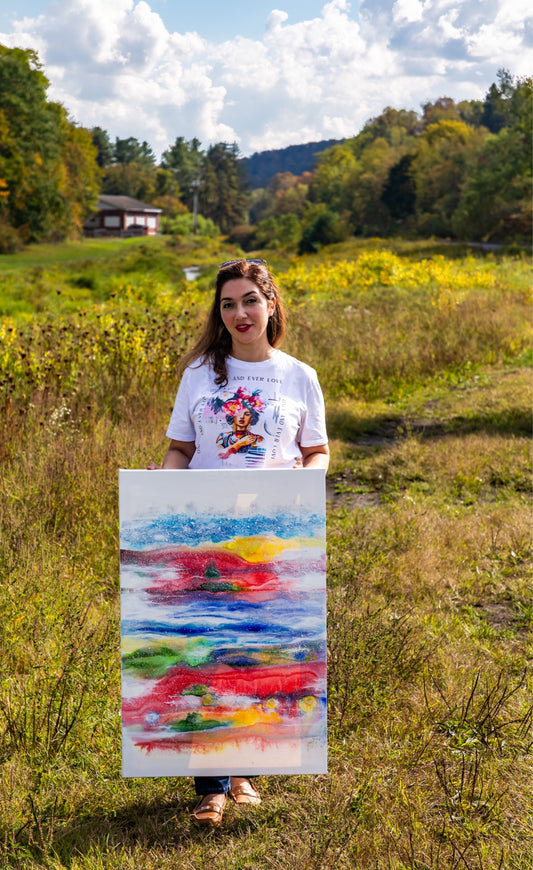 maryam mohi holds her painting as the artist who enjoyed her residency in Patton PA in L.A. Studio residency